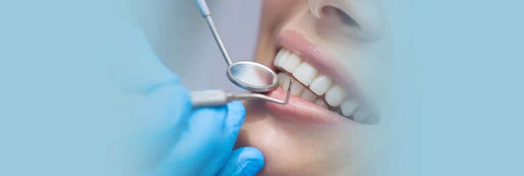 A close up of a dentist inspecting some teeth.